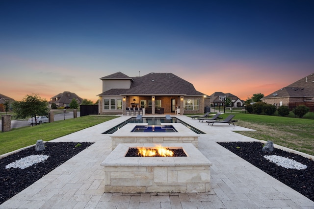505 Eloise Dr, Heath, TX 75032 - back of house featuring a fire pit, fence, a patio area, a lawn, and brick siding