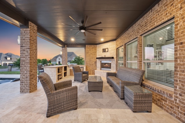 505 Eloise Dr, Heath, TX 75032 - patio terrace at dusk with a ceiling fan and an outdoor living space with a fireplace