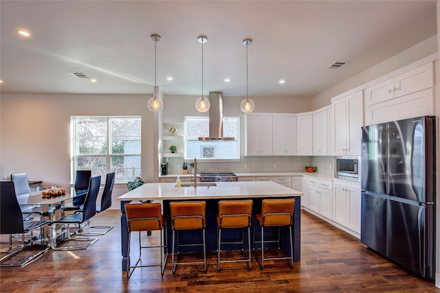 6702 Tyree St, Dallas, TX 75209 - kitchen featuring appliances with stainless steel finishes, wall chimney exhaust hood, a sink, light countertops, and tasteful backsplash