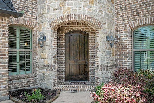 doorway to property with brick siding