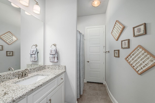 full bathroom featuring a shower with curtain, tile patterned floors, baseboards, and vanity