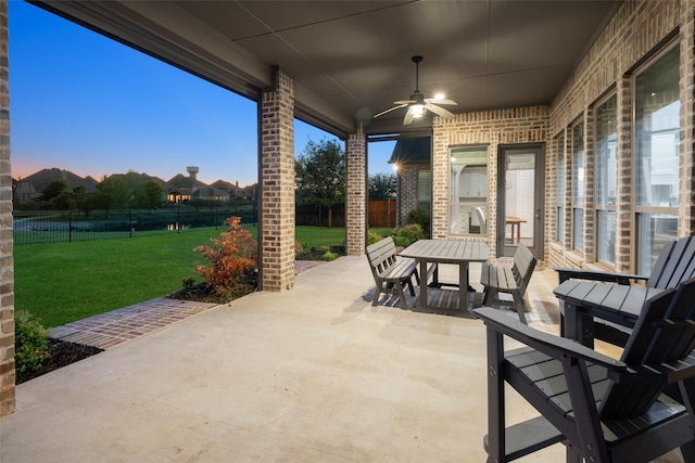 view of patio with ceiling fan, outdoor dining area, and a fenced backyard
