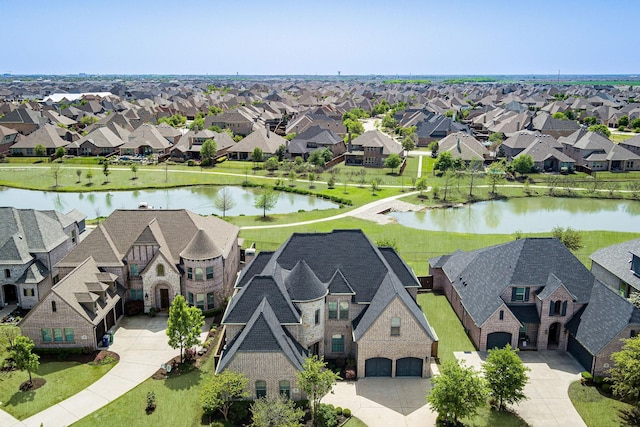 birds eye view of property with a residential view and a water view