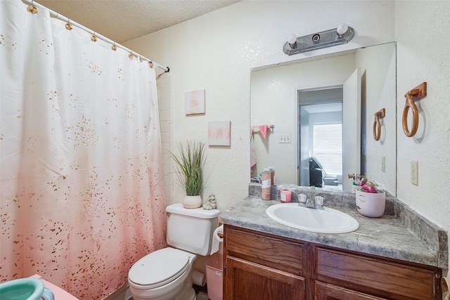 bathroom with toilet, a textured ceiling, curtained shower, and vanity