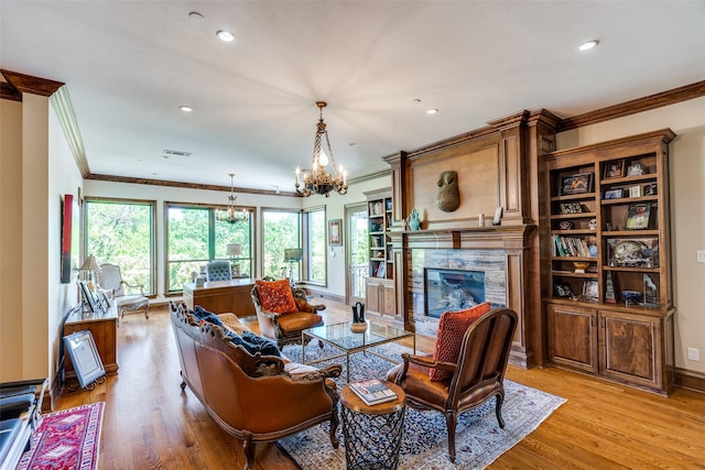 dining area with a chandelier, light wood-type flooring, crown molding, and recessed lighting