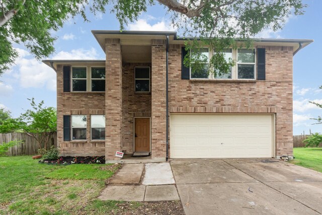 525 Butch Cassidy Dr, Anna, TX 75409 - view of front of house featuring an attached garage, driveway, and brick siding
