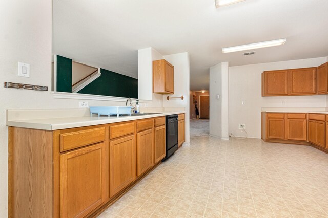 525 Butch Cassidy Dr, Anna, TX 75409 - kitchen featuring dishwasher, light countertops, brown cabinetry, light floors, and a sink