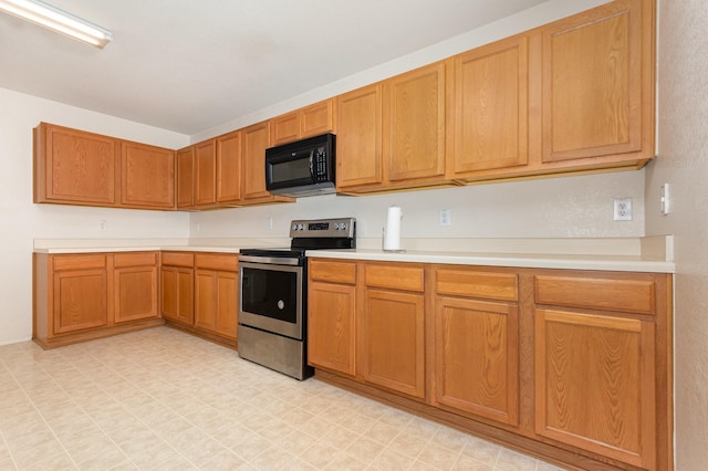 525 Butch Cassidy Dr, Anna, TX 75409 - kitchen featuring black microwave, stainless steel range with electric stovetop, light countertops, and light floors