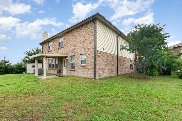 525 Butch Cassidy Dr, Anna, TX 75409 - back of house featuring a patio, brick siding, a chimney, a lawn, and central air condition unit