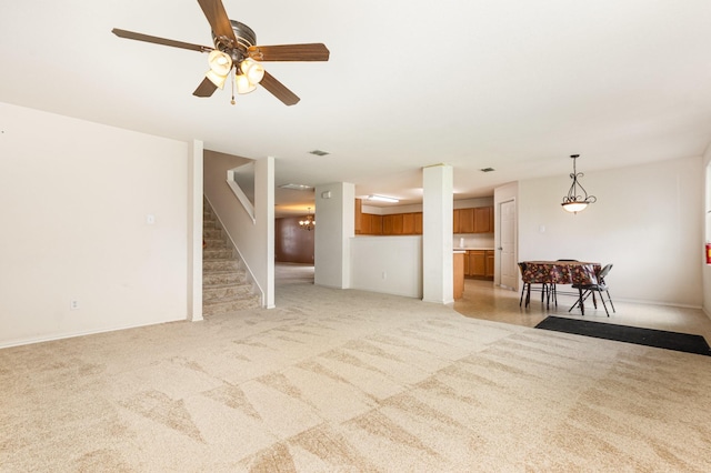 525 Butch Cassidy Dr, Anna, TX 75409 - living area with light carpet, stairs, and a ceiling fan
