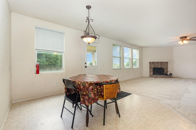 525 Butch Cassidy Dr, Anna, TX 75409 - dining area with ceiling fan, a fireplace, light floors, and baseboards