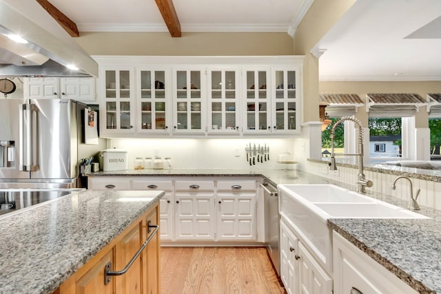 334 Pleasant Acres Rd, Rockwall, TX 75087 - kitchen with exhaust hood, light stone countertops, a sink, glass insert cabinets, and appliances with stainless steel finishes