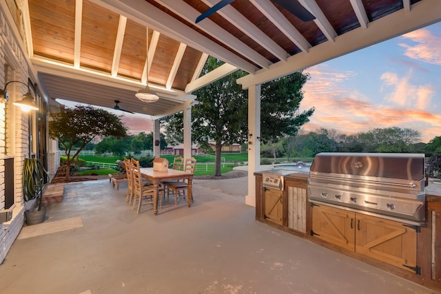 334 Pleasant Acres Rd, Rockwall, TX 75087 - patio terrace at dusk featuring outdoor dining space, an outdoor kitchen, and a grill