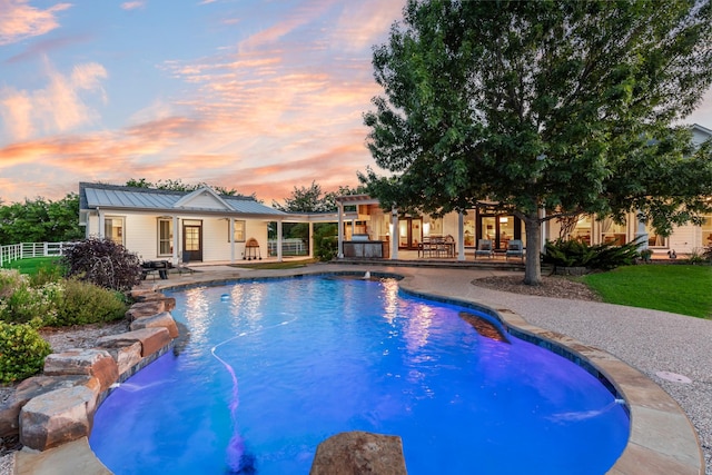 334 Pleasant Acres Rd, Rockwall, TX 75087 - pool at dusk with fence, an outdoor pool, and a patio area