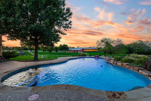 334 Pleasant Acres Rd, Rockwall, TX 75087 - pool at dusk featuring a lawn, fence, and an outdoor pool