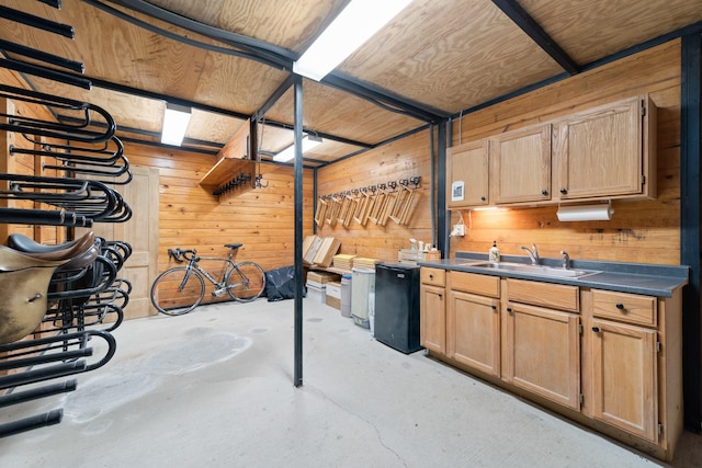 334 Pleasant Acres Rd, Rockwall, TX 75087 - interior space with a sink, concrete floors, dark countertops, wooden walls, and refrigerator