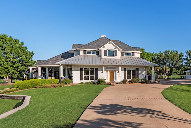 334 Pleasant Acres Rd, Rockwall, TX 75087 - view of front facade with metal roof, a standing seam roof, driveway, and a front yard