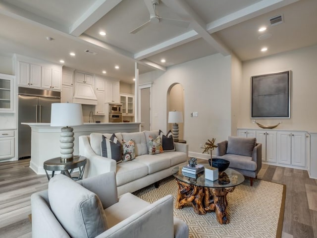 living room with visible vents, ceiling fan, beam ceiling, light wood-type flooring, and recessed lighting