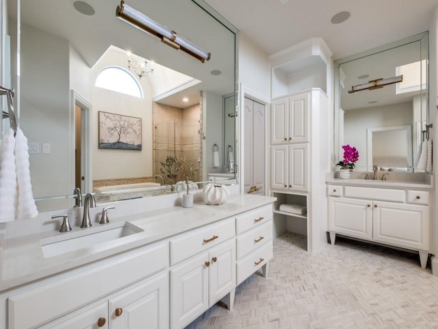 full bath featuring a garden tub, vanity, and a stall shower