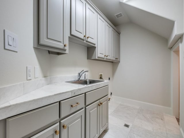 laundry room featuring hookup for an electric dryer, a sink, cabinet space, hookup for a washing machine, and visible vents