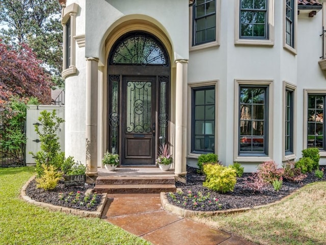 doorway to property featuring stucco siding
