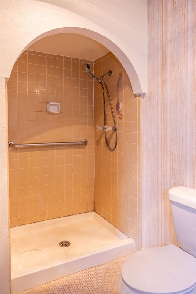 bathroom featuring a stall shower, toilet, and tile patterned flooring