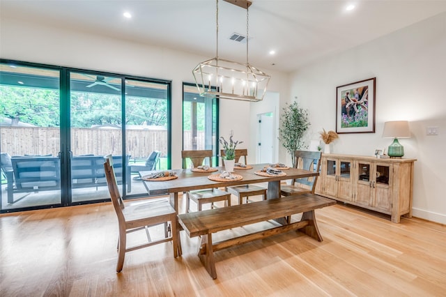 dining room featuring visible vents, a notable chandelier, light wood-style flooring, and recessed lighting