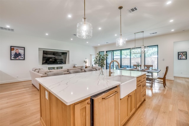 kitchen featuring visible vents, recessed lighting, light wood-type flooring, and a sink