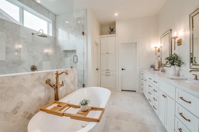 full bathroom with a sink, a stall shower, double vanity, and a freestanding tub