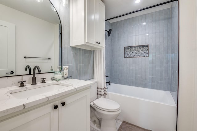 full bathroom featuring shower / bathtub combination with curtain, vanity, and toilet