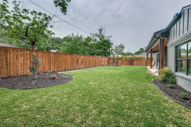view of yard with a fenced backyard