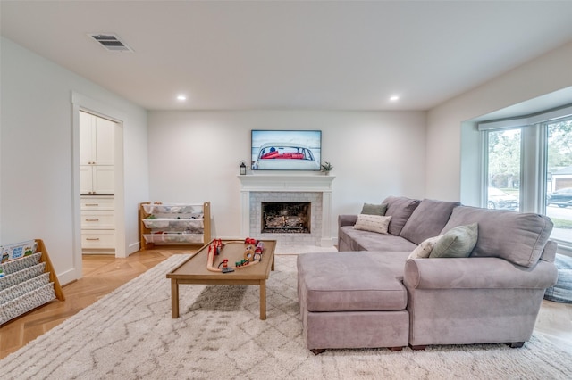 living area with a fireplace, visible vents, and recessed lighting