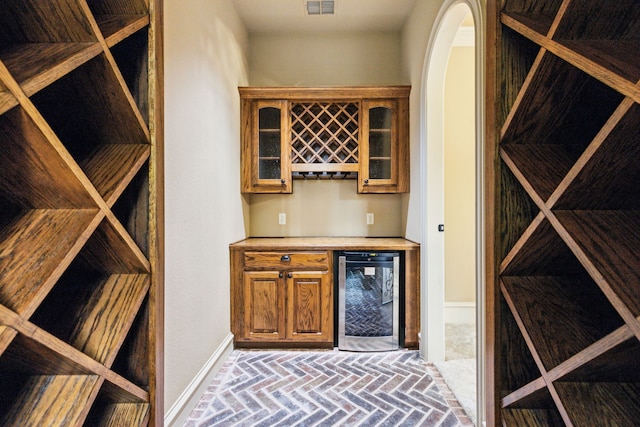 1233 Deer Lake Dr, Frisco, TX 75036 - wine area featuring wine cooler, baseboards, a bar, and brick floor