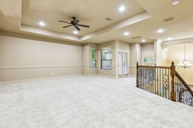 1233 Deer Lake Dr, Frisco, TX 75036 - spare room with carpet flooring, a tray ceiling, visible vents, and ceiling fan with notable chandelier
