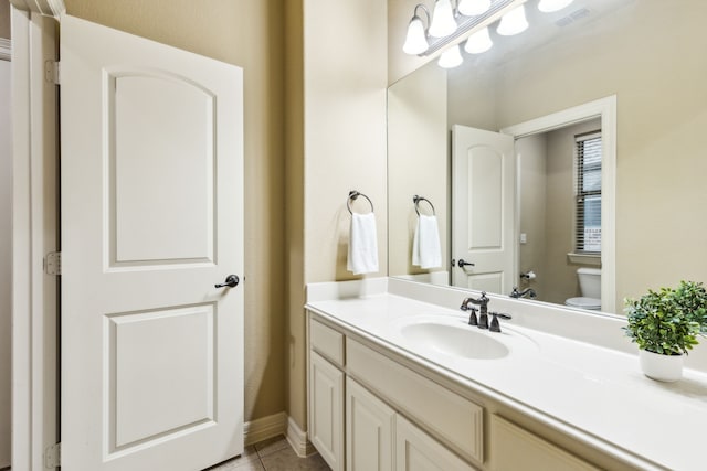 1233 Deer Lake Dr, Frisco, TX 75036 - bathroom featuring toilet, visible vents, baseboards, tile patterned flooring, and vanity