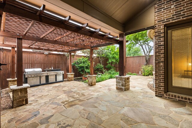 1233 Deer Lake Dr, Frisco, TX 75036 - fenced backyard featuring a patio area, a pergola, a grill, and a sink