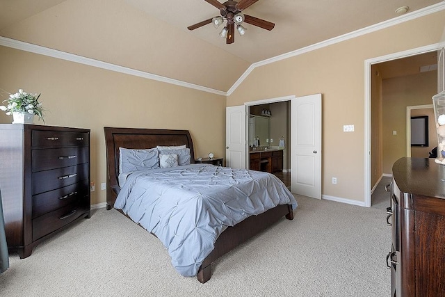 bedroom featuring crown molding, light carpet, baseboards, lofted ceiling, and ensuite bathroom
