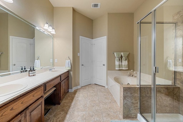 bathroom with a garden tub, double vanity, a sink, and a shower stall