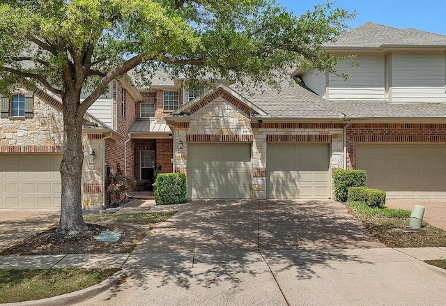 view of front of property with driveway, stone siding, a shingled roof, and brick siding