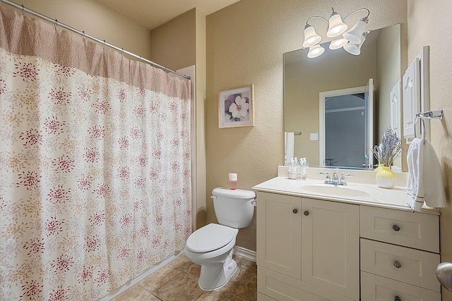 bathroom featuring tile patterned flooring, toilet, a textured wall, vanity, and curtained shower