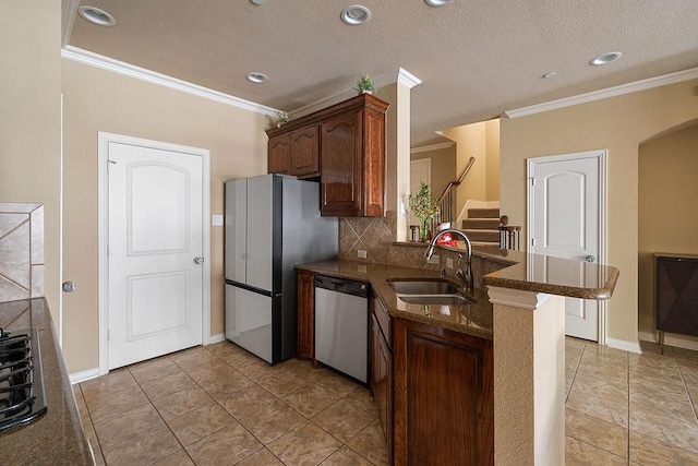 kitchen with ornamental molding, stainless steel dishwasher, a peninsula, and a sink