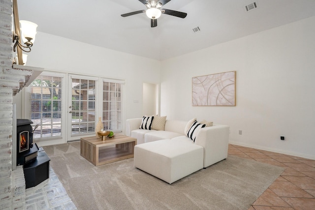 4703 El Brevo Ct, Arlington, TX 76017 - living area featuring baseboards, visible vents, a ceiling fan, and a wood stove