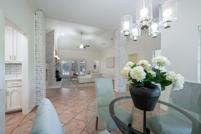 4703 El Brevo Ct, Arlington, TX 76017 - dining space featuring light tile patterned floors, baseboards, a brick fireplace, high vaulted ceiling, and ceiling fan with notable chandelier
