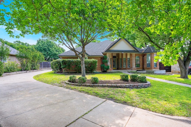 4703 El Brevo Ct, Arlington, TX 76017 - view of front of house featuring covered porch, brick siding, fence, and a front lawn