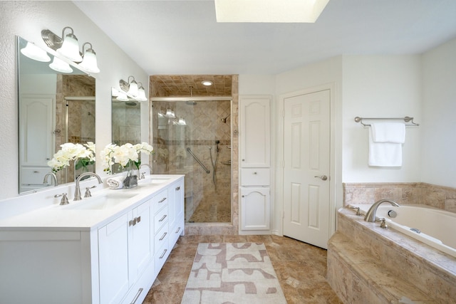 4703 El Brevo Ct, Arlington, TX 76017 - bathroom with a sink, double vanity, a stall shower, a bath, and a skylight