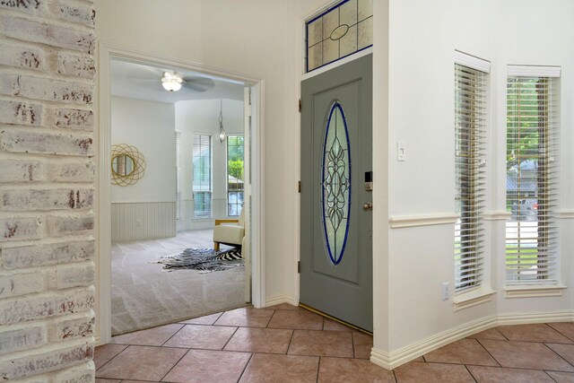 4703 El Brevo Ct, Arlington, TX 76017 - carpeted foyer featuring a ceiling fan, tile patterned flooring, and wainscoting