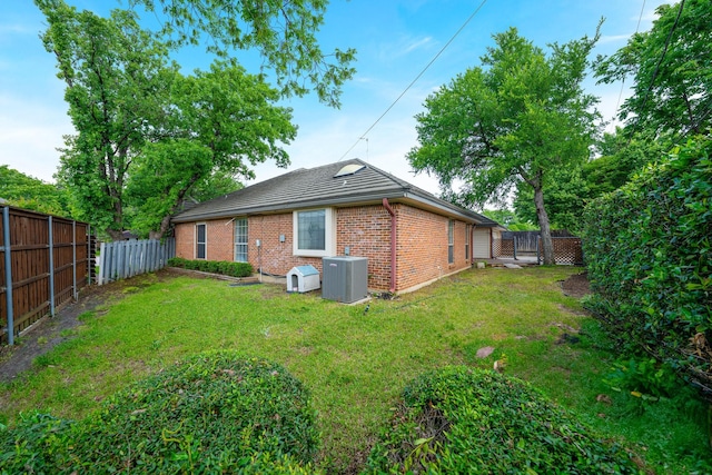 4703 El Brevo Ct, Arlington, TX 76017 - rear view of property with a yard, central AC unit, a fenced backyard, and brick siding