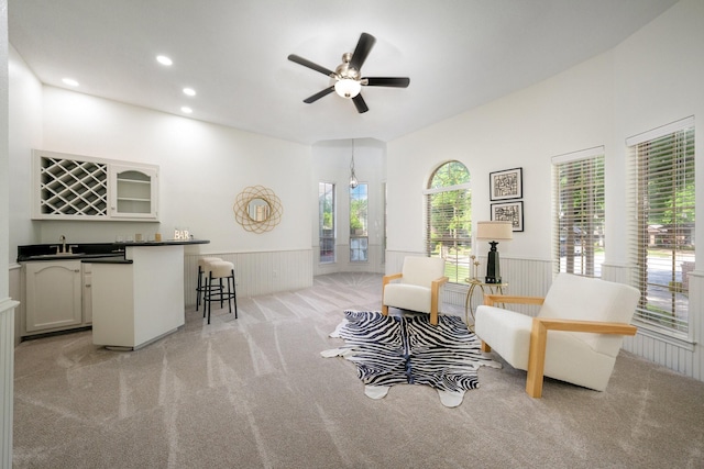 4703 El Brevo Ct, Arlington, TX 76017 - living room featuring recessed lighting, indoor wet bar, a wainscoted wall, light carpet, and a ceiling fan