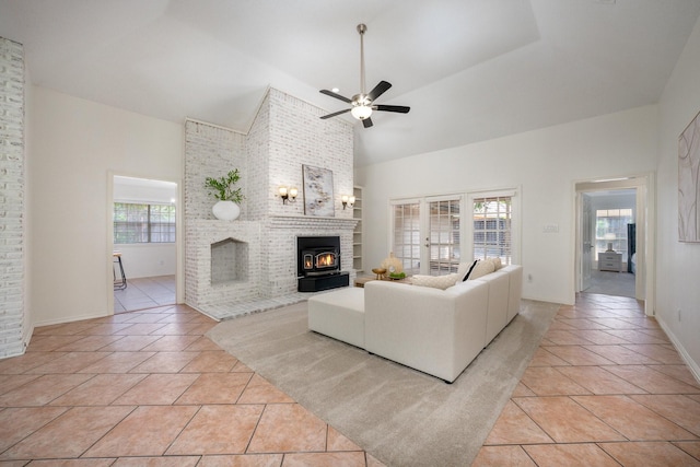 4703 El Brevo Ct, Arlington, TX 76017 - living room with a fireplace, light tile patterned floors, high vaulted ceiling, a ceiling fan, and baseboards