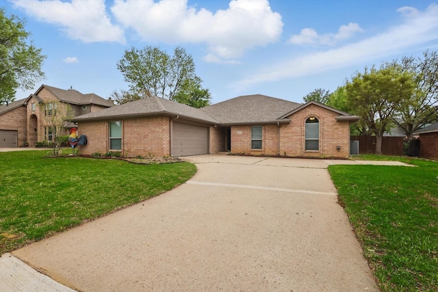 single story home with a front lawn, brick siding, and a garage